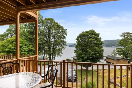Lake George resort deck with table and chairs overlooking the lake.