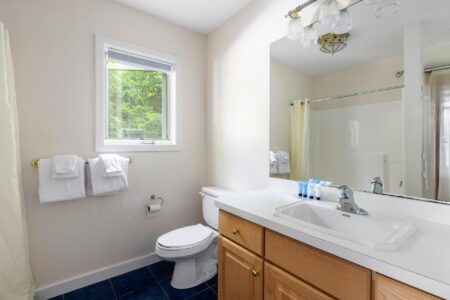 a bathroom area featuring a big basin and mirror at Lake George hotels
