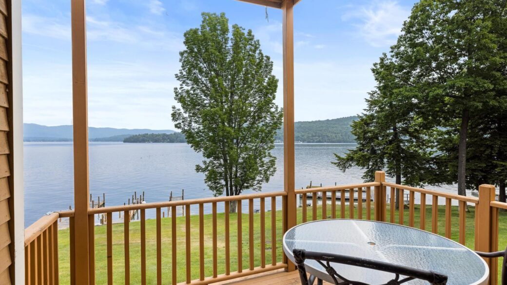 Lake George lodging with a deck and chairs overlooking the lake.