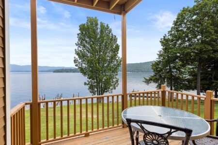 Lake George lodging with a deck and chairs overlooking the lake.