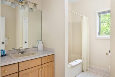 A Lake George resort featuring a bathroom with a sink, toilet, and shower.