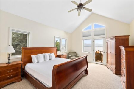 Lake George lodging with a king size bed and a ceiling fan.