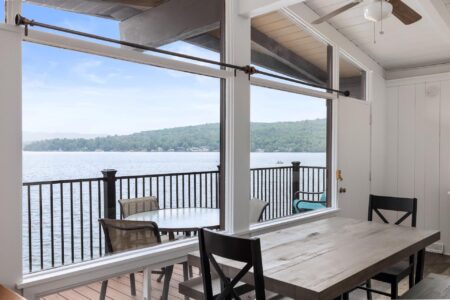 A stunning dining room offering breathtaking views of Lake George in one of the best hotels for a memorable Lake George vacation.