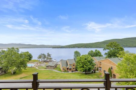 A picturesque view of a lake and mountains from the Erlowest resort balcony.