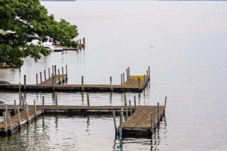 A boat dock in Lake George with a boat.