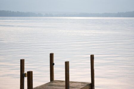 A dock on Lake George with mountains in the background