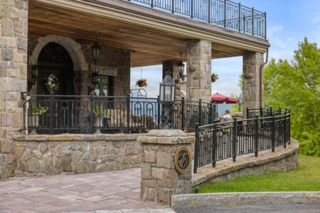 Lake George lodging with stone house and wrought iron railings.