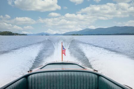A Lake George resort showcasing the back of a boat adorned with an American flag.