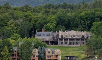 A large house sits on the shore of Lake George.