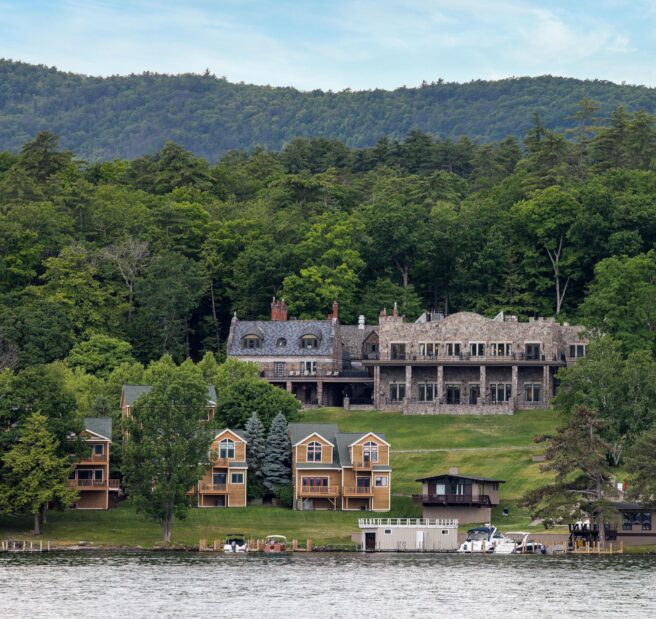 A large house sits on the shore of Lake George.