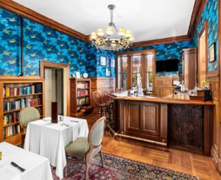 Lake George lodging with bookshelves and blue wallpaper.