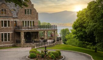 The Erlowest which provides Luxury Lodging in the Adirondacks sits amidst a manicured garden with Lake George, mountains and a beautiful sunset.