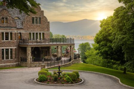 The Erlowest which provides Luxury Lodging in the Adirondacks sits amidst a manicured garden with Lake George, mountains and a beautiful sunset.