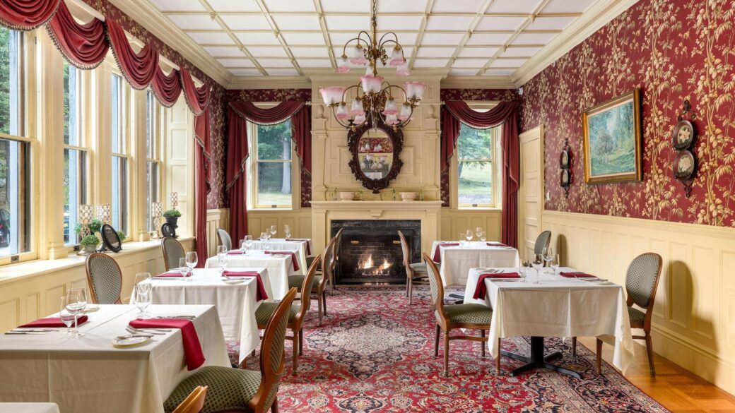 Erlowest offers a Lake George lodging experience with an ornate dining room featuring a fireplace.