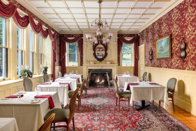 Erlowest offers a Lake George lodging experience with an ornate dining room featuring a fireplace.