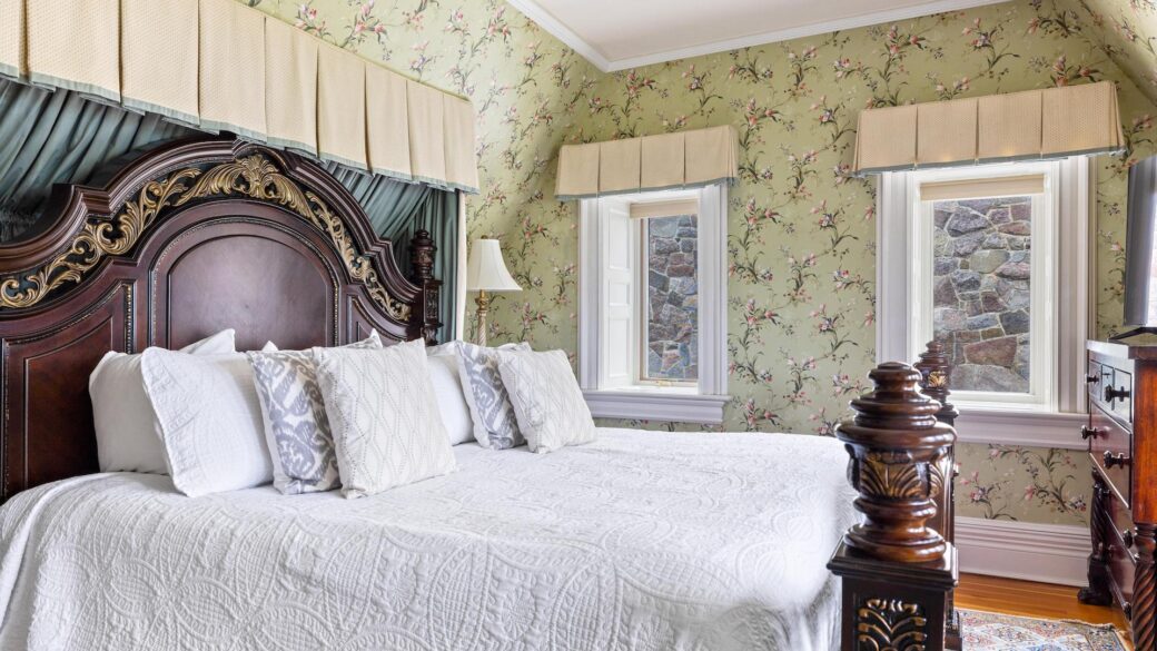 Lake George lodging with floral wallpaper in bedroom.