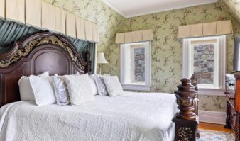 Lake George lodging with floral wallpaper in bedroom.