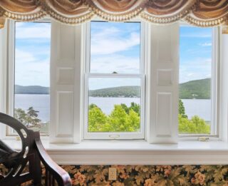 A Lake George lodging with a large window overlooking Erlowest.