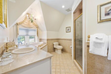 A bathroom with a sink, toilet and shower found at the Erlowest, one of the best hotels in Lake George resort