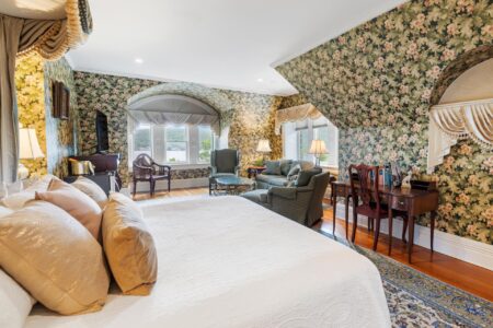 A floral-themed bedroom in a Lake George resort with a comfortable bed
