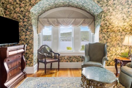 A Lake George lodging option with a floral wallpapered living room and television