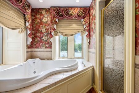Lake George hotel with a beautiful bathroom featuring floral wallpaper and a tub