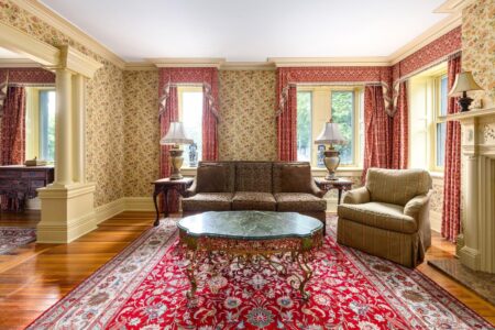 A Lake George lodging boasting a cozy living room adorned with a fireplace and a rug.