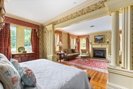  bedroom with ornate walls and a fireplace in one of the best hotels in Lake George, Erlowest.