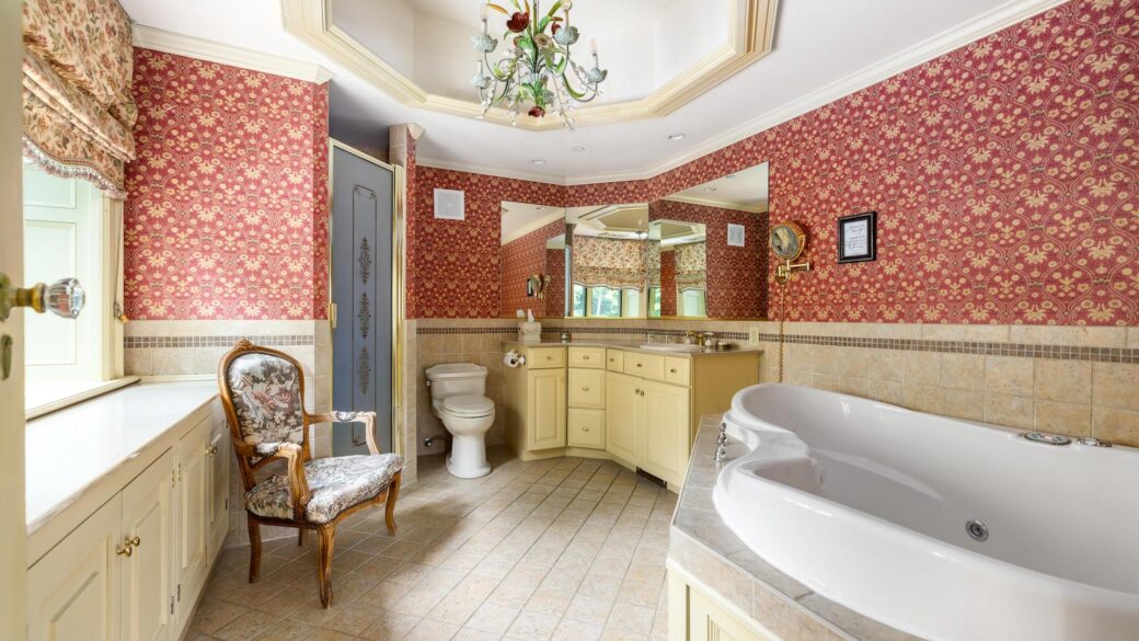 Lake George lodging with a bathroom featuring red wallpaper and a bathtub.