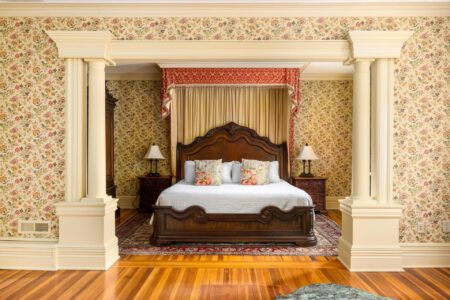 Lake George lodging: A bedroom with floral wallpaper and a bed.