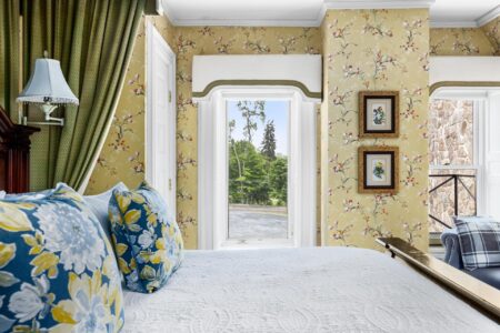 A floral-themed bed in a Lake George resort room at Erlowest.
