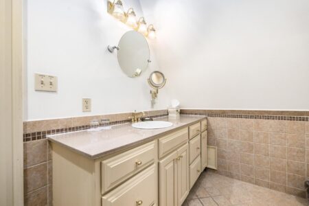 A Lake George hotel with beige tile and a mirror.