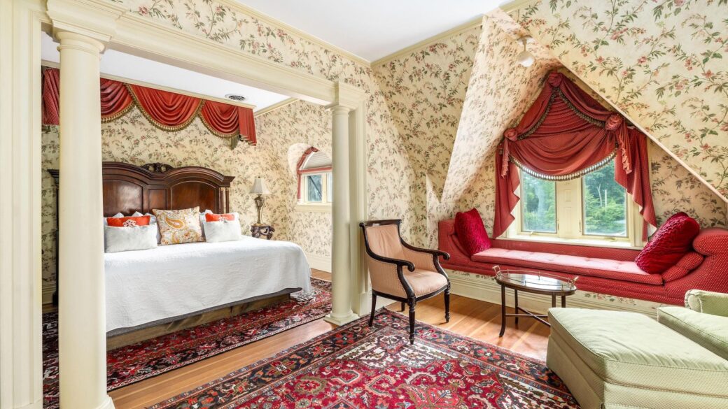 An ornate bed and window in a Lake George hotel.