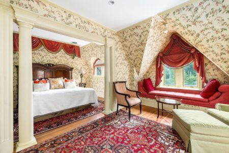 An ornate bed and window in a Lake George hotel.