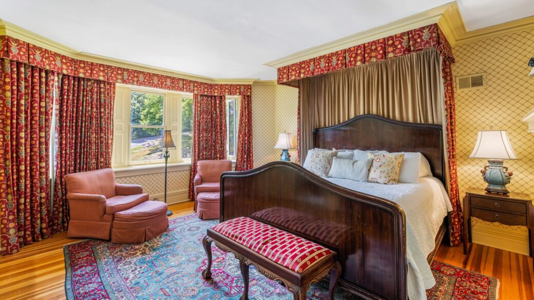 A Lake George suite with a bed and a chair.