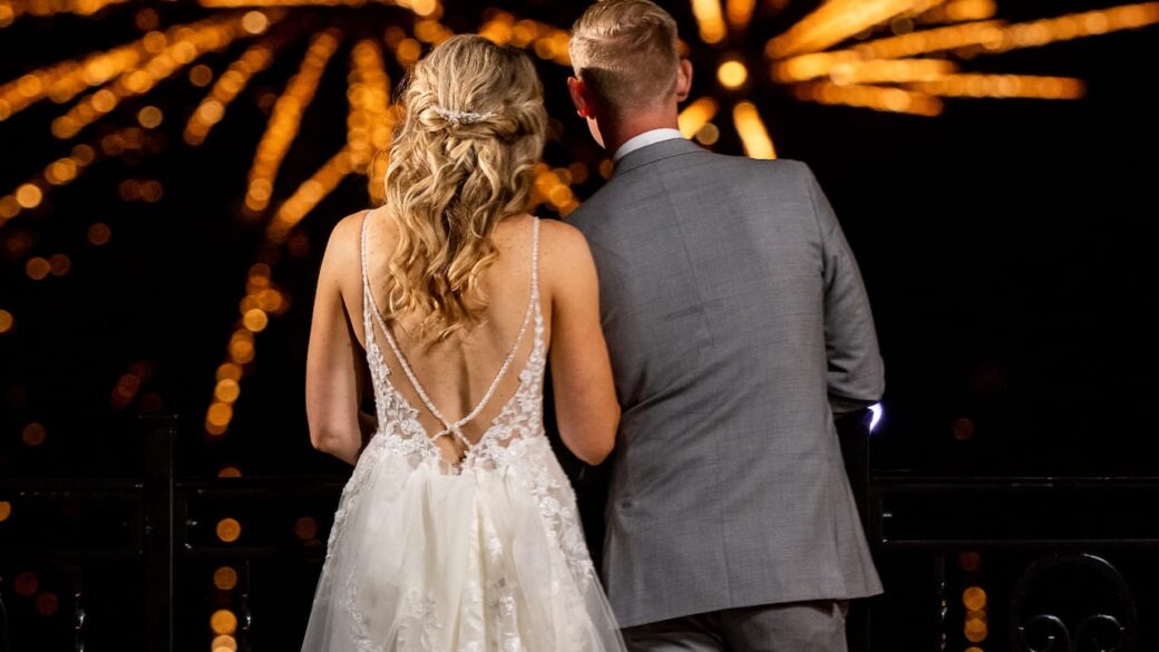 A couple celebrating their wedding at Erlowest, a Lake George resort, with a stunning firework display.