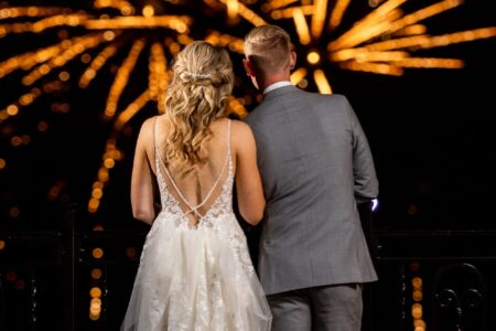 A couple celebrating their wedding at Erlowest, a Lake George resort, with a stunning firework display.