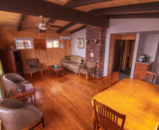 A wide view of a cozy living room with a dining area.