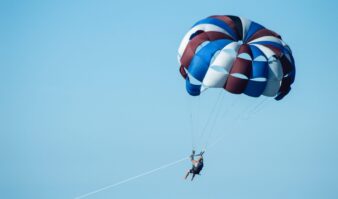 A person parasailing during their Lake George vacation.