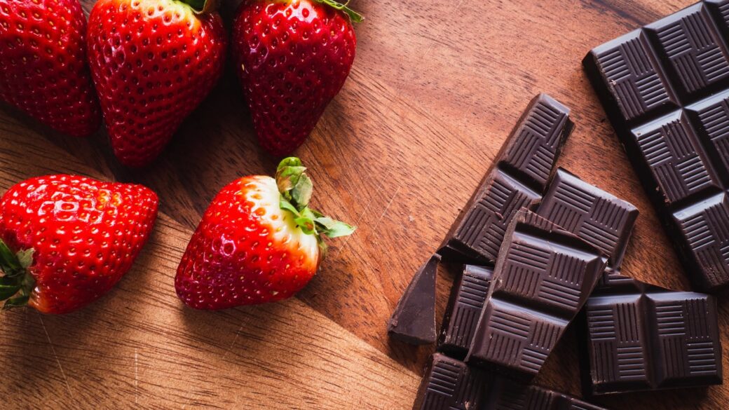Best hotels in Lake George offering chocolate and strawberries on a wooden table.