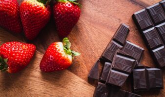 Best hotels in Lake George offering chocolate and strawberries on a wooden table.