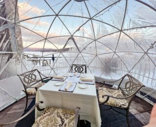A table inside an igloo with a view of the snow.