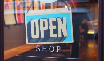 An open shop sign in the window of a shop close to The Erlowest