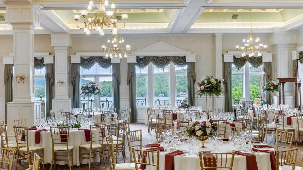 A large ballroom with tables and chairs set up for a wedding reception.