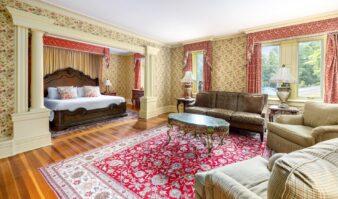 An ornately decorated bedroom with a bed and couch.