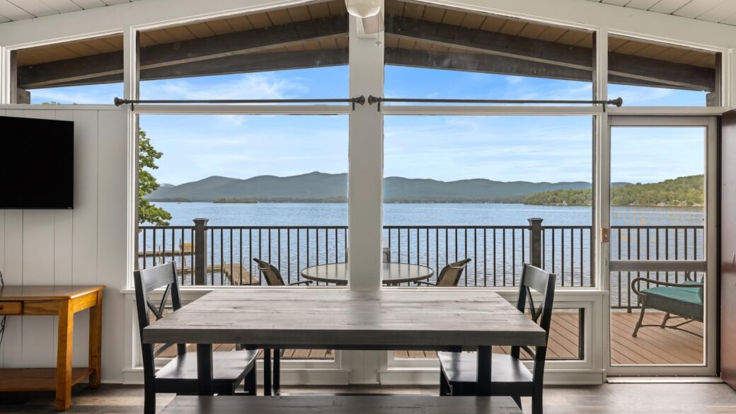 A dining room with a view of the lake.