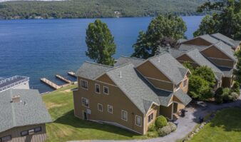 An aerial view of Lake George with houses on the shore.