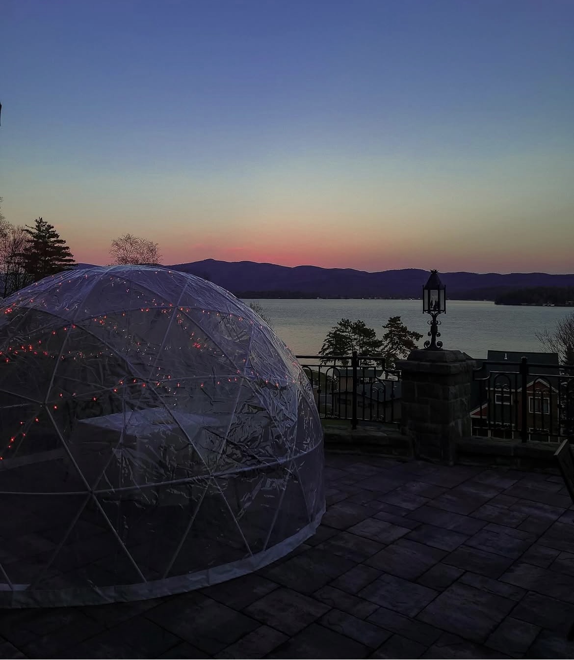 Outdoor Igloo Dining Dome in front of Lake George during sunset