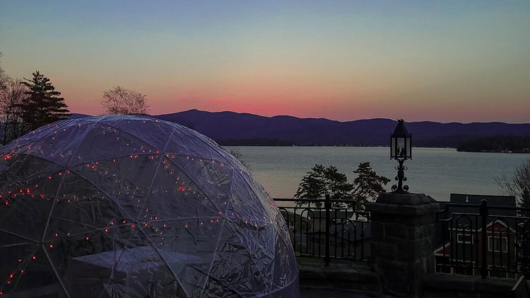 Outdoor Igloo Dining Dome in front of Lake George during sunset